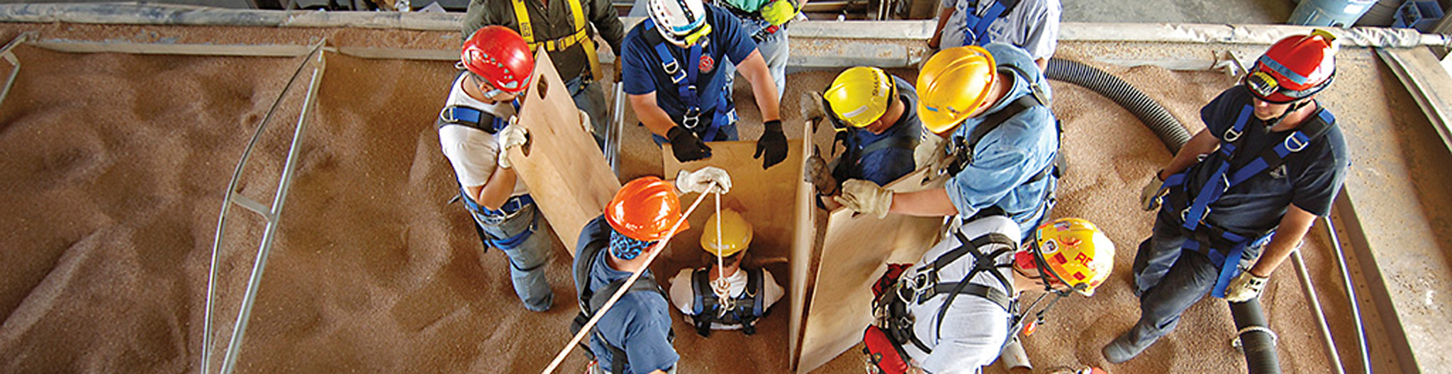 Firefighters performing a grain bin rescue exercise